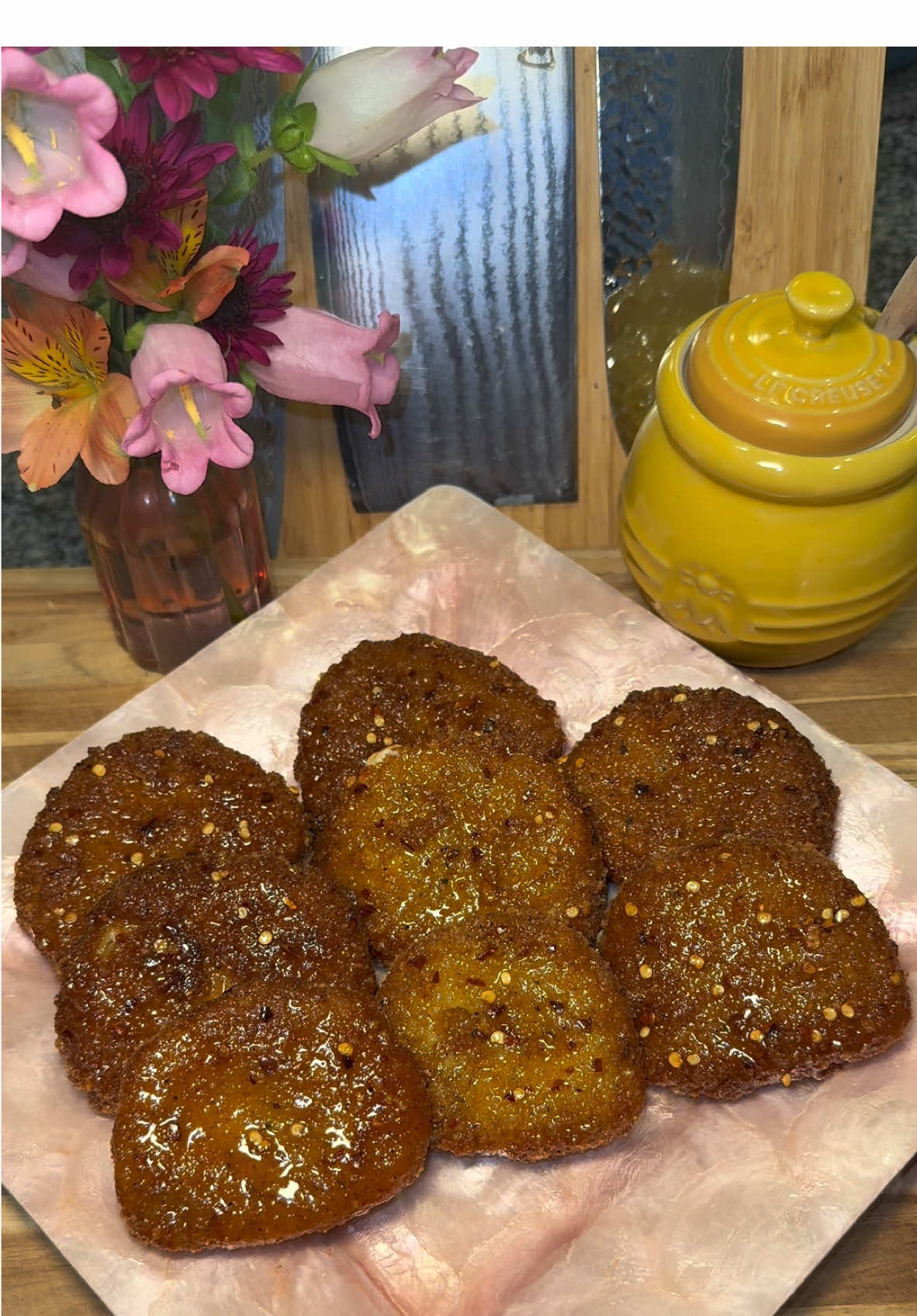 Hot Honey Fried Mozzarella🌶️🍯 Start out by getting fresh Mozzarella cheese and cut it into thick slices.  Make sure you’re not using the Mozzarella that comes soaking in liquid, use the Mozzarella that comes in a package, and make sure to dry off any excess liquid.  Then add flour to one plate, and in another plate add 1 part Italian seasoned breadcrumbs and 1 part panko breadcrumbs.  Season both plates, today I’m using: -garlic powder  -Greek seasoning  -white pepper -creole seasoning  Then dip the cheese slices into the flour, then into whisked eggs, and pack on the breadcrumbs.  Then dip them into the whisked eggs again, and add on another coat of breadcrumbs. (We double bread these to ensure the cheese doesn’t leak.)  When you’re done breading them, pop them into the freezer for no less than 2 hours.  Then fry these (straight from the freezer) in oil heated to about 350 degrees until they’re golden brown, letting them rest on a cooling rack.  For the hot honey glaze, in a pan on medium low heat add: -2 tablespoons of butter  -1/2 cup of honey  -2 tablespoons of Crystal hot sauce  -1 tablespoon of apple cider vinegar  -chili pepper flakes  -cayenne pepper  -salt to taste Coat your cheese with the hot honey while they’re on the cooling rack (I prefer to only coat the top half and keep the bottoms clean.) Enjoy💜 #Recipe #cheese #hothoney #cheesepull #recipes #food 