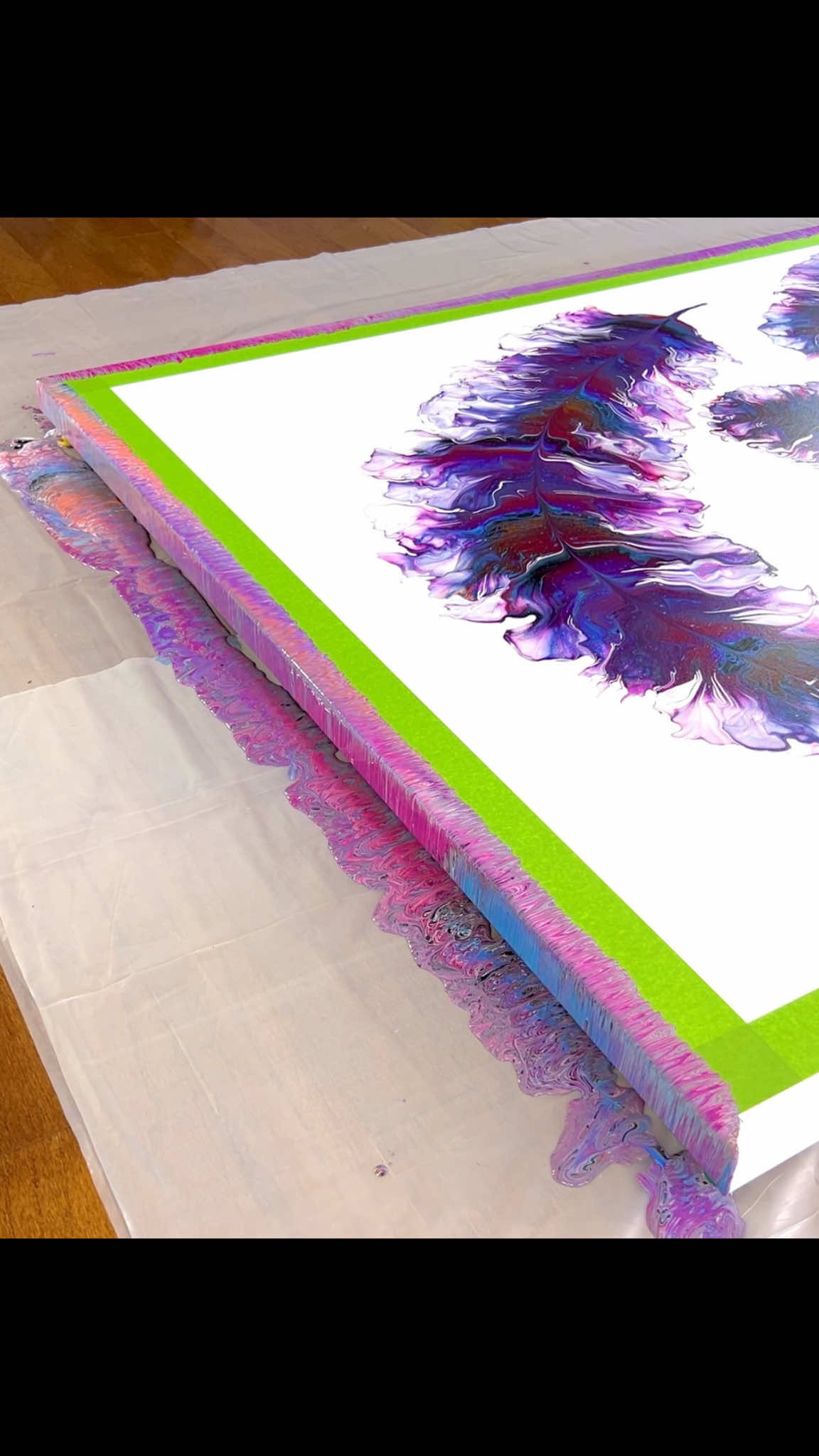 Creation Video Part 2 for Cascade of Ascension 🩷🧡💙🖤🪶 (Feathered Odyssey Series) 48x60 acrylic on gallery wrapped canvas In Part 2 of creating these feather paintings, I’m using the colors in the feathers to create a border that flows over onto the edges of the canvas. This one has a magenta, orange, blue, black, and white frame and it is the perfect finishing touch for an extra splash of color and intrigue.  #colorfulabstractart #acrylicpour #fluidart #colorfulart #eyecandyart         