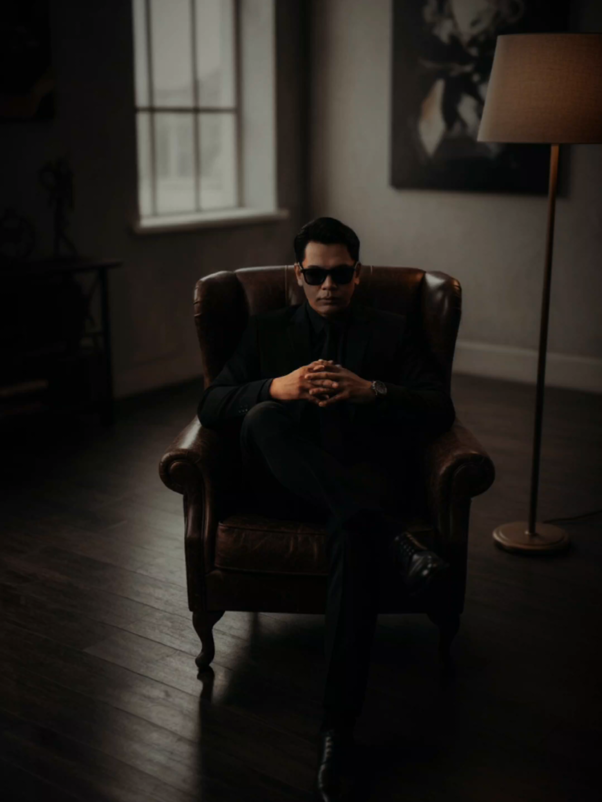 TUTORIAL POTRET BOS GENGSTER 1. Buka AI (chat GPT / Gemini) bebas  2. Lampirkan foto kalian (wajah jlas / tdk terhalang)  3. Masukan prompt Using the photo uploaded above create A hyper-realistic 8K cinematic overhead shot of a stylish man from the photo keep his features and don’t edit or retouch his face seated in a vintage leather armchair, positioned in the center of a large, moody room with wooden flooring and warm ambient lighting. The man is wearing an all-black formal suit, black tie, black dress shoes, and dark sunglasses, exuding a powerful, calm 'boss' aura. He sits with confident posture - legs crossed like a true leader, arms resting assertively on the chair's armrests. A laptop is placed on the wooden floor beside him showing green matrix-style code, with a closed book nearby. A floor lamp to the right casts a warm golden glow, while soft daylight enters through a corner window. The environment features soft shadows, a shallow depth of field, and a slightly desaturated background to enhance the dramatic, cinematic feel. The tone is bold, minimalistic, and commanding. Maintain facial features make no changes to the face no editing or retouching.  #kontenai #googlegemini #mafia #trend #chatgpt 