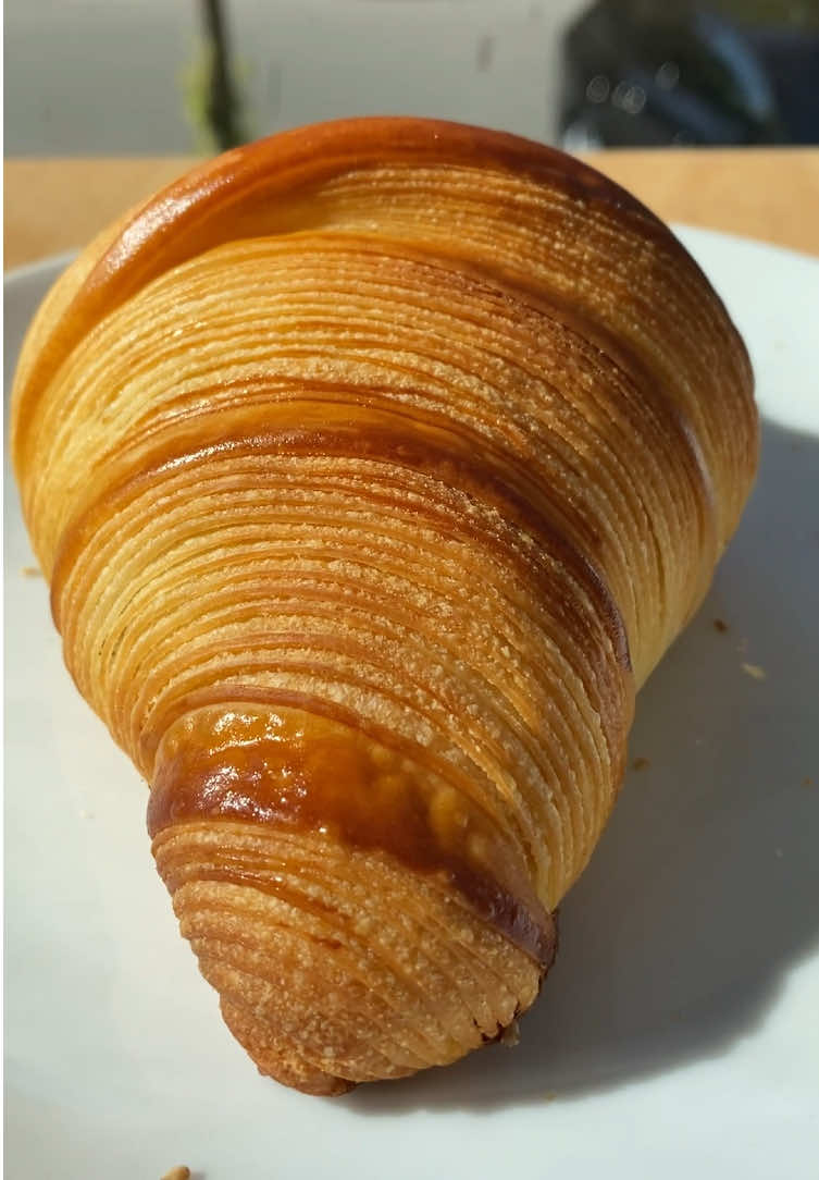 Hand made croissants with recipe 🥐 😉  Ingredients 📝  - 605 grams flour roughly 12% protein (I used 50/50 14% and 11% flour. - 66 grams sugar - 2 tsp yeast - 1 tbsp salt - 125g milk - 220g water - 60g butter for dough - 340g butter for lamination - 30g flour for lamination butter. - Egg yolk for egg wash - Splash of milk for egg wash Mix dough preferably in mixer until a windowpane forms. Does not have to be full windowpane. Put immediately into freezer for 20 minutes and then fridge overnight. Let butter soften and mix with the lamination flour until fully incorporated. This adds more flexibility to the butter. Roll butter into 20x20cm square with parchment paper or plastic bag with similar size. And put into fridge.  Next day take out the butter block, wait until it softens slightly (10 minutes) and beat until pliable with a rolling pin (5 minutes roughly) Roll out dough to a bit more than 40cm and 20cm wide. Put the butter block on top and encase it. Roll out until roughly 5mm. Do a book fold or 4 fold. Flatten slightly to about 2ish centimeter. Freeze on both sides for 4 minutes. Put into fridge for 20-25 minutes. Wait until dough is 15c on the surface and roll out again this time doing a letter or a triple fold. Freeze as last time.  For the last roll out, get the dough to 36 centimeters on one side and cut into 4x 9cm slabs. Put in freezer with plastic wrap for about 10-15 minutes. Roll each slab out until around 4mm in thickness (freeze the dough if it gets too warm. It should feel very firm. Cut diagonally and form into croissants.  Put into oven at around 28c (not too warm) with high humidity from for example very hot water in a pan put into the bottom of the oven. Proof until wiggly and visibly bigger around 2 1/2 hours. Mix egg wash, brush thé croissants gently with it à bake at 170c with fan until dark golden brown. And most importantly enjoy your fresh croissants! 🥐  #baking #croissant #satisfyingfood #homebaker #baker 