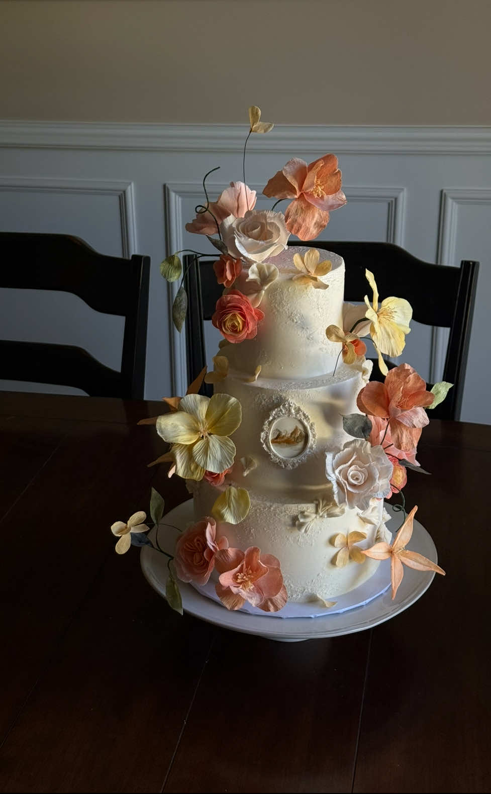 24 flowers 9 leaves  343 petals 8 stamens 1 fondant picture frame & mountain motif & a few piped petals to top it off  each petal & leaf, cut & textured by hand, & dusted with color nothing makes me happier than seeing a cake covered in flowers 🌸 #cakedecor #cakedecorating #sugarflowers #weddingcake #bride 
