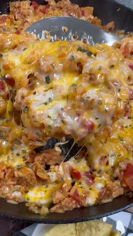 Cheesy Chicken Taco Rice is an easy one pan meal my family loves!  INGREDIENTS 1 lb of chicken breast, cut into cubes   1 tbsp olive oil  1/2 tsp each salt and pepper 2 tsp chili powder 1 tsp each of cumin and dried cilantro 1 tbsp minced garlic  10 oz can of Rotel (not drained)  8 oz can of tomato sauce  1 1/2 cups of chicken broth 1 cup of long grain white rice (uncooked & rinsed)  2 cups of shredded Colby Jack cheese  Sour cream  Cilantro  Buffalo Wild Wing’s Southwest Ranch INSTRUCTIONS.  Add the chicken with 1 tbsp of oil to a large skillet over medium-high heat, add all seasonings, and cook until the chicken is cooked through.  Add the untrained Rotel, tomato sauce, minced garlic, chicken broth, and uncooked rice to the skillet. Stir well, make sure to bring the whole skillet to a boil, cover with a lid, and cook on medium-low heat for about 15-20 minutes or until rice is cooked (I stirred it once about half way through).  Top with shredded Colby Jack cheese and let it melt or pop in the oven on broil. Serve and top with sour cream, cilantro, and Southwest Ranch sauce. Serve with tortilla chips. Enjoy!  #EasyRecipes #tacorice #onepanmeal #dinner 