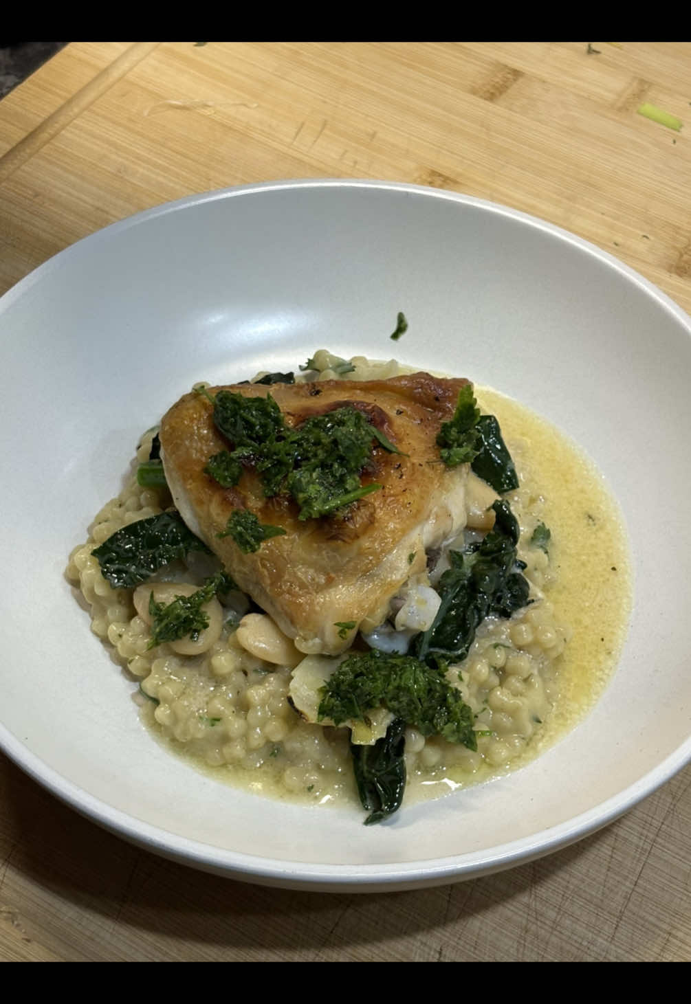 Chicken thigh with giant couscous, butter beans and other stuff