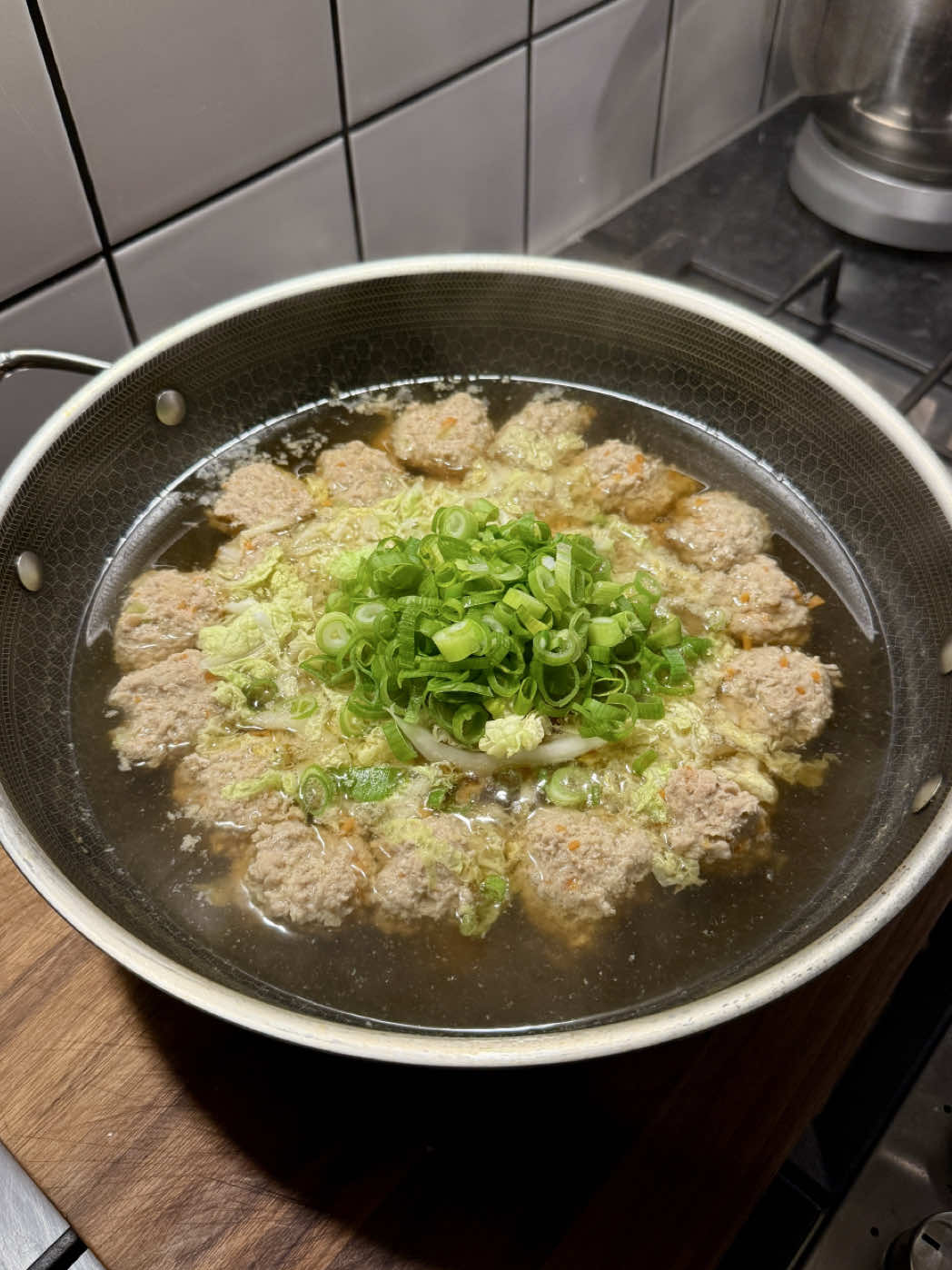 Chinese meatball and cabbage soup! Dreamy midweek recipe that’s quick, nutritious and comforting. Love how this recipe is traditional but also easy to follow and make. Most of the ingredients are Chinese pantry staples, you can also use chicken or beef mince if you prefer. Use mum’s trick for shaping the meatballs too, saves so much time - no need for perfect round balls  Serves 3 For the soup: 60g carrot  40g ginger  600g Chinese leaf  3 spring onions 1.5L water 2 tbsp chicken bouillon powder 1 1/2 tsp white pepper  2 tbsp light soy sauce 1/2 tsp sea salt flakes 1 tbsp sesame oil For the meatballs: 500g 20% fat pork mince 1/2 tsp white pepper 1 tbsp chicken bouillon powder 1 1/2 tbsp cornstarch 1 tbsp light soy sauce 1 tbsp oyster sauce 1 tbsp shaoxing wine 1 tbsp sesame oil  1 egg  Mince the carrot, smash 30g of ginger and finely mince the remaining 10g. Thinly slice the Chinese leaf and separate the whites and greens of the spring onions. In a bowl, combine the minced carrot, ginger and the whites spring onions with the pork mince. Add all seasonings except the egg, and mix thoroughly. Then add the egg and slam the mixture down - folding and pressing it (this helps create a bouncy texture). Heat the smashed ginger in a wok or pot over medium heat for 1 minute to release its aroma. Add 1.5L water, white pepper, light soy sauce and sea salt flakes. Let it simmer briefly for 2 minutes.  Cup a portion of the meatball mix in your hand, close your fist and squeeze the meatball out - this shapes it neatly and keeps it compact. Gently add the meatballs to the simmering broth. Cover with a lid and cook until the meatballs are tender and cooked through (about 8–10 minutes). Remove the lid, add the sliced Chinese leaf and green spring onions. Simmer for 2-3 more minutes until wilted. Drizzle with sesame oil before serving.