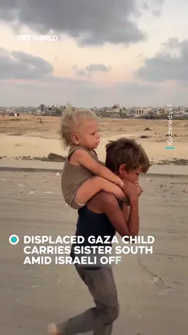 A displaced child from northern Gaza, in tears, carries his younger sister while walking south under dire humanitarian conditions caused by Israel's offensive on the enclave. #gaza #palestine #Israel #genocide #freepalestine 