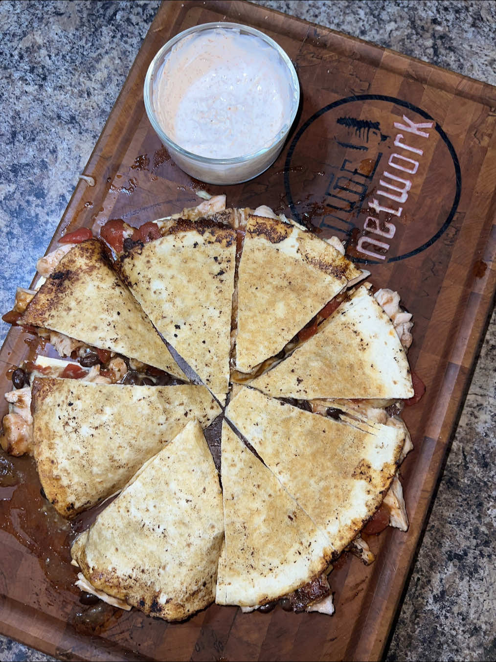 May I interest you in a dude sized quesadilla fit for any tailgate?!? Ingredients are easy to bring along wherever you need to go as well! Springer Mountain Farms chicken has all the options and @Bearmountain BBQ has all the smoke flavors you’d need like this sweet cherry to pair with chicken! @redneckchefboudreaux fajita seasoning! #TheDudeNetwork #fuelyourflavor #tailgatefood #tailgaterecipes #dudefood 