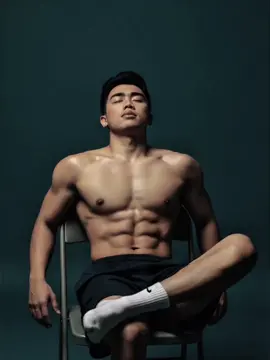 Use this Gemini Ai Prompt ➡️Use the model(person in the image) to create a studio photo with the same backgorund color, featuring a young man sitting casually on a metal folding chair with his legs crossed. He is wearing nothing in the top, shorts, and white socks. Seeing his bulky chest and have 8 packs of abs. The lighting is soft and minimal, producing sharp shadows and a moody atmosphere. His pose is relaxed, slightly leaning with one hand on the chair's backrest, his face turned to above. The background is plain, with a simple and modern aesthetic. ⬅️ #geminiai #trending #fyp #CapCut 