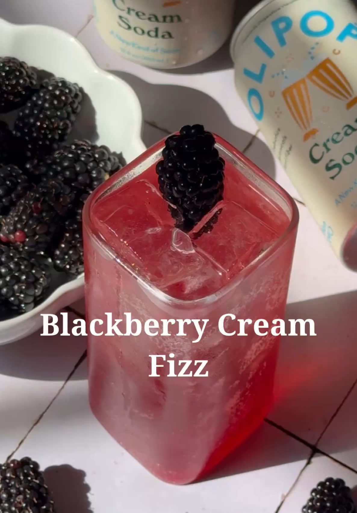 🍇🥤 @My friends call me Bev + OLIPOP are raising a glass to Friday with the Blackberry Vanilla Fizz…our take on an Italian soda that’s creamy, tart, and moody for fall. 📌 Save this one bc it’s basically made for Halloween parties. 🕸️✨
 
 Blackberry Cream Fizz
 
 Ingredients: 
 OLIPOP Cream Soda 
 Blackberry syrup* 
 Blackberry for garnish 
 
 *Blackberry syrup:
 1/2 cup sugar
 1/2 cup water
 1/2 cup blackberries 
 Juice from half a lemon Directions:
 1. Add blackberries, sugar, lemon juice and water to a medium sauce pan over medium heat. 
 2. Bring to a boil and stir occasionally. 
 3. Gently mash the blackberries to release all the juice. 
 4. Let simmer for about 10 minutes. 
 5. Remove from heat and allow to cool before use.
 6. CHEERS! 