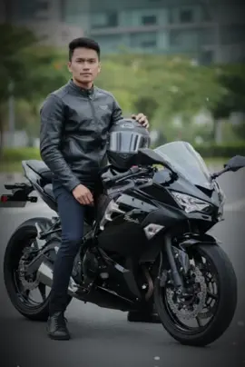 Step 1: Open your GEMINI AI  Step 2: Upload your Photo  Step 3: Copy this prompt 👇 Hyper-realistic 8K full-body portrait of a young man sitting confidently on a black Kawasaki Ninja sport motorcycle, wearing a sleek black leather jacket with a subtle logo on the chest, dark fitted jeans, and black sneakers. He holds a black full-face helmet casually on the motorcycle tank. His pose is relaxed but cool, exuding confidence. The background is a realistic urban outdoor setting with a clean asphalt road, soft natural sunlight, and blurred green trees or modern buildings in the distance for depth. The lighting is balanced, with soft shadows and slight highlights on the bike to show its glossy finish. Ultra-detailed textures on the motorcycle (reflections on the fairings, visible brake discs, chain, and tires), realistic skin tones, and cinematic contrast. Slight depth of field to focus on the man and the bike, with the background artistically blurred. High-quality, professional photography style, like a premium motorcycle magazine photoshoot.