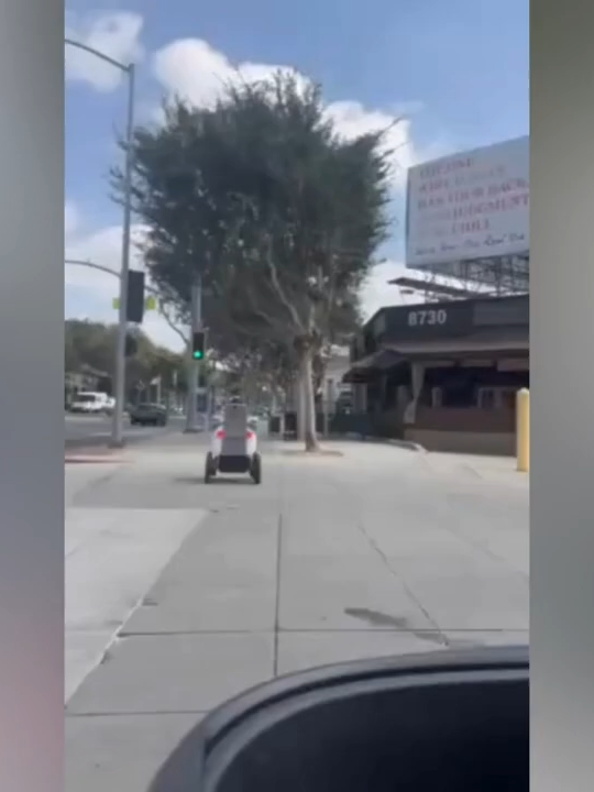 WATCH THIS 🚨 In West Hollywood, a man with cerebral palsy on his mobility scooter says a food delivery robot collided with him after cutting him off on the sidewalk. The moment was caught on video and has raised serious questions about robot safety, sidewalk access, and how companies remotely operate these machines—especially around people with disabilities.    The incident happened on a busy sidewalk near Santa Monica Boulevard, where the robot — operated by Serve Robotics — allegedly failed to yield, cutting across the man’s path and causing a minor collision. Though he wasn’t seriously injured, the man says the encounter left him shaken and frustrated. He’s now calling on West Hollywood city officials to reevaluate the pilot program that allows autonomous delivery bots on public sidewalks. Disability advocates say these machines often violate ADA protections, and critics argue they pose risks to seniors and people with mobility challenges. Serve Robotics responded, saying “Safety is paramount” and that they’re reviewing the incident. City council members are expected to revisit the issue in upcoming meetings. #BreakingNews#WeHo#Accessibility#DisabilityRights#collision#FoodDeliveryRobot#PublicSafety#LA#TechEthics#foryoupage❤️❤️#FYP#TrendingNow #deliveryrobot#WeHoAccessibility#TikTokNews#FYP#ServeRobotics#MobilityRights#TrueStoryTikTok#sidewalk#CerebralPalsyAwareness#AutonomousTechDebate#ADACompliance#WestHollywoodNews#RobotCollision#DisabilityJustice#ViralVideoAlert