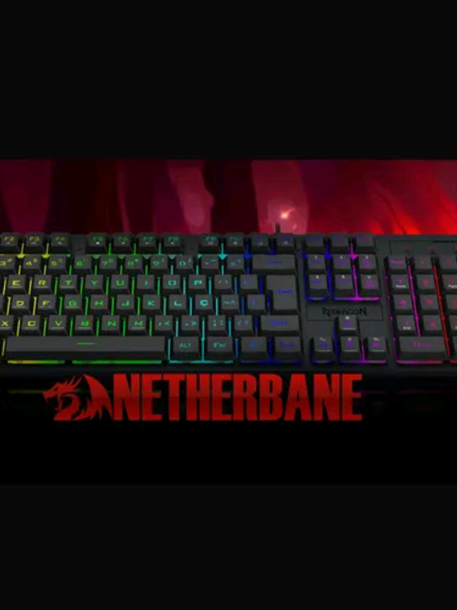 Descubra a arma secreta para o seu setup: o Redragon Netherbane! 💥 Este teclado não é só um acessório, é um upgrade completo para suas partidas. Com switches mecânicos Outemu, você tem a velocidade e a precisão que cada clique exige. O Netherbane vem com um design tenkeyless (TKL), perfeito para quem precisa de mais espaço no mousepad. A estrutura compacta e robusta, com acabamento em alumínio, garante durabilidade e estabilidade nas batalhas mais intensas. E para completar, a iluminação RGB com 18 modos diferentes te permite personalizar o teclado e deixar seu setup com a sua cara. Se você busca performance, durabilidade e estilo, o Redragon Netherbane é a escolha certa! #Redragon #RedragonBrasil #TecladoMecanico