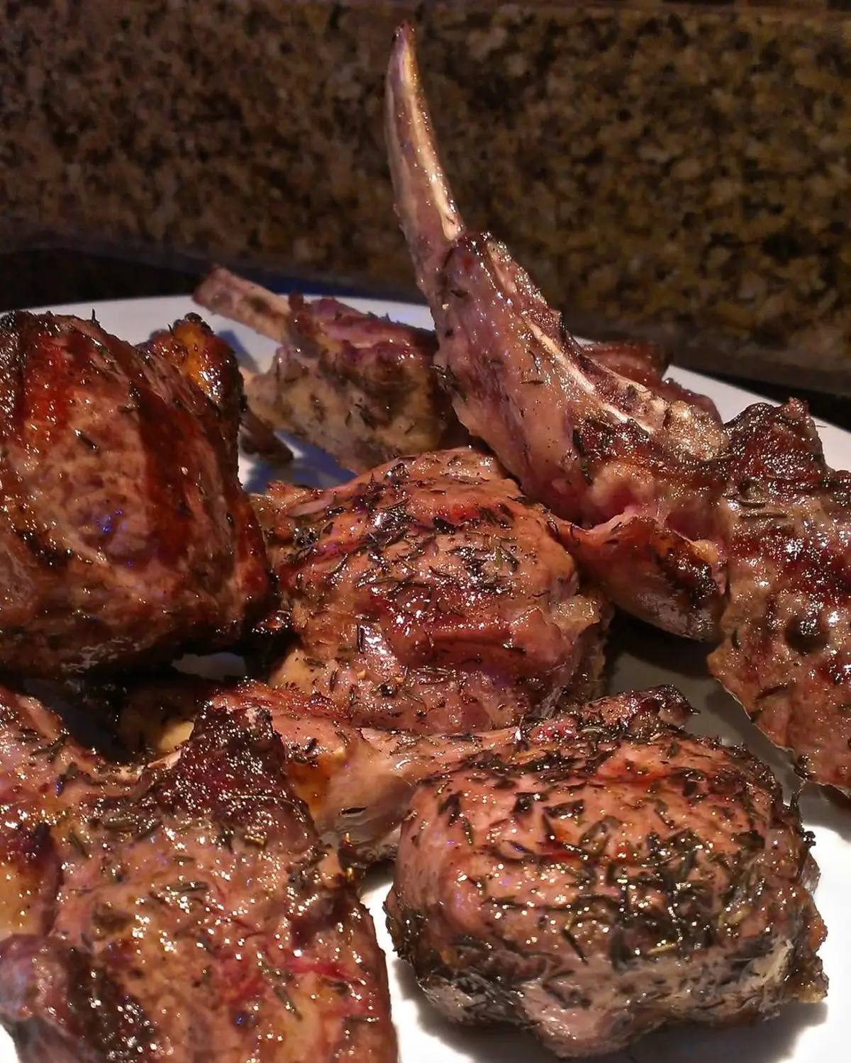 Grilled Paidakia A staple in Greek tavernas, these succulent chops are traditionally marinated overnight, then grilled quickly over hot coals, arranged on a large platter and drizzled with fresh lemon juice just before serving. Ingredients: 2 racks of lamb, cut into single chops 1/3 cup extra-virgin olive oil Zest of 2 lemons (before zesting, scrub the lemon with a vegetable brush under cool water) 8 cloves garlic, minced 1 tablespoon dried oregano 2 tablespoons fresh rosemary or 1 tablespoon dried rosemary 2 teaspoons Kosher salt 1 teaspoon freshly-ground black pepper For serving: The juice of the two zested lemons. After zesting the lemons for the marinade, leave them whole, then slice in half and squeeze over cooked chops just before serving. I prefer using the zest in the marinade which has provides lemony flavor without the citric acid in the juice, which can make the meat mushy if left on too long. Adding the juice at the end brings bright flavor without breaking down the protein. Directions: In a small bowl, mix the olive oil, lemon zest, garlic, oregano, rosemary, salt and pepper, mashing the herbs with the back of a teaspoon to release the volatile oils. Place the chops in a Pyrex baking pan and pour the marinade over them. Toss, using clean hands to make sure the meat has been completely covered. Cover with plastic wrap and marinate the chops in the refrigerator for at least 2 hours or preferably overnight, turning the meat from time to time. Half an hour before cooking, take the chops out of the refrigerator remove from the marinade and place them in a shallow roasting pan, allowing them to rest and come to room temperature. While the chops are resting, preheat a gas grill to high. When ready to cook turn the heat down to medium high and depending on their thickness grill the chops 3-5 minutes per side for medium rare, basting with the remaining marinade when they are turned. Transfer the chops to a warm serving platter, loosely cover with foil and rest for 5 minutes. Drizzle with fresh lemon juice and serve. Serve 4-6