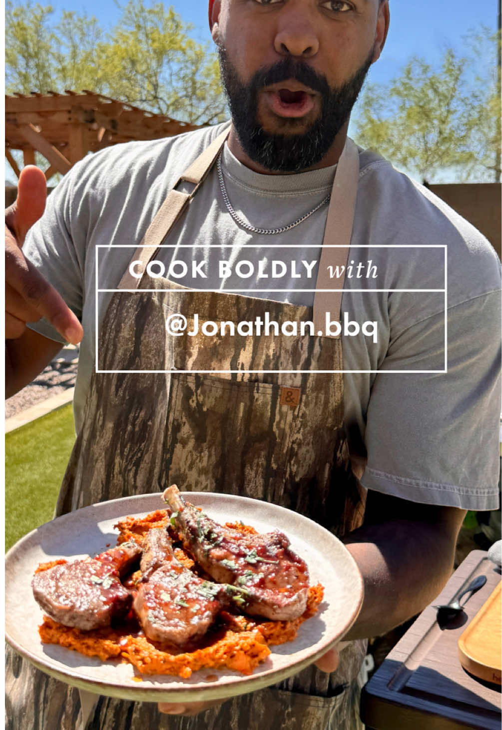 Grilled Lamb Chops on a bed of Grilled Carrot & Garlic Mash. Backyard vibes meet fine dining. Getting it all done in my RealTree x @Hedley & Bennett apron. INGREDIENTS: - Lamb chops (8) - Olive oil - Salt & black pepper - Minced garlic  - Carrots (8) - Butter - Fresh parsley (chopped for garnish) - Harissa paste (2 tbsp) - Honey (2 tbsp) - Red wine vinegar (1 tbsp) INSTRUCTIONS: - Rub lamb chops with olive oil, salt, and black pepper. Let sit at room temp while you prep veggies. - Slice carrots lengthwise. Toss with olive oil, salt, pepper. - Place on the indirect side of your grill at medium heat. Cook until carrots are fork-tender. - In a small grill-safe pan, combine harissa, honey, and vinegar. - Warm until smooth and glossy. Set aside. - Place chops over indirect heat until they hit ~120°F internal. - Move to the hot side of the grill and sear 1–2 minutes per side until crusty and 130–135°F (medium-rare). - Brush with the smoky honey harissa glaze during the final sear. - Rough chop grilled carrots and mash in a bowl with minced garlic and butter. - Spread carrot-garlic mash as a base on the plate. - Layer lamb chops on top. - Drizzle extra glaze over the chops. - Finish with chopped parsley.