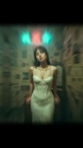 Prompt: Use the photo attached as the reference. Create a photorealistic Hong Kong retro portrait with authentic 1990s film look, like a moody movie still. Strictly preserve identity (eyes shape, lips, nose bridge, jawline, skin tone). Vertical portrait, mid-thigh to head (3/4 body). Subject standing, leaning slightly toward camera with both hands resting on a small wooden cabinet behind her; shoulders relaxed. Chin slightly down, gaze up toward camera with a melancholic, calm expression. Scene: tight messy Hong Kong room, walls plastered edge-to-edge with yellowed Cantonese newspapers. Behind subject: hazy neon Chinese signage (red + cyan) glowing through mist near the ceiling. Cluttered furniture: compact cabinet, scattered cables, small mirror edge visible. Wardrobe & Styling: cream/ivory lace corset-style dress (tasteful, non-revealing), layered delicate gold necklaces, small hoop or pearl earrings. Hair tousled with wispy bangs across forehead. The face must be a precise copy of my real facial features, do not change the face, and make it a high-resolution photo.. #gemini 