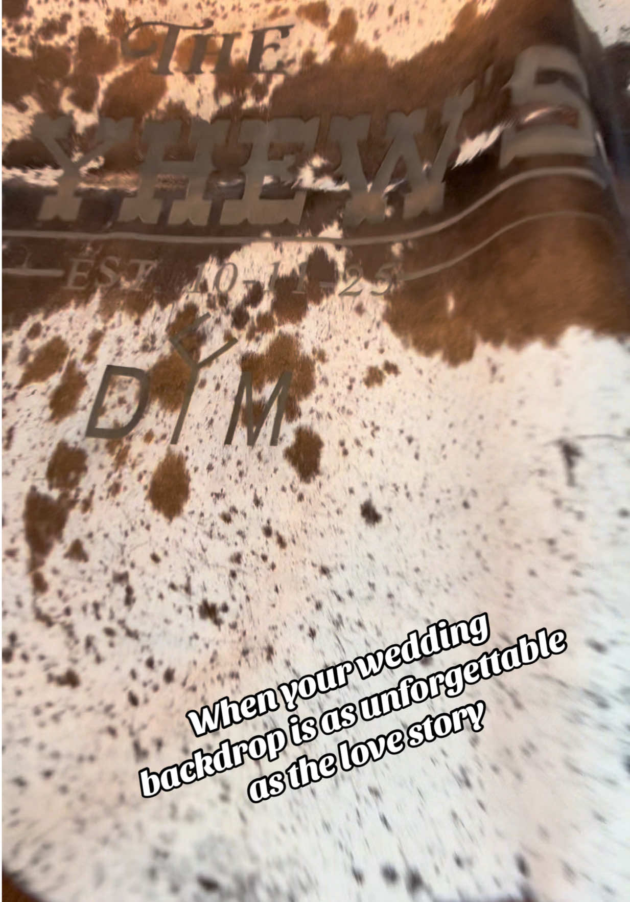 DelRay’s custom cowhide backdrop is giving all the western wedding vibes ✨ Ready to make your day just as unique? Message us today! #westernwedding #weddingvibes #weddingday #weddinginspo #rusticwedding 