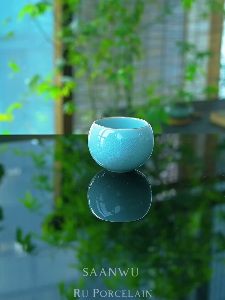 Dragon’s Egg Ru Porcelain Ice-cracks Host Tea Cup * Ru Porcelain sky-blue glaze with Ice-cracks patterns. *The ice crack pattern is a type of crack found in Ru porcelain or Ge kiln crackle glaze, known for its strong three-dimensional effect and a layered, stacked appearance, resembling the cracks of ice, which is how it got its name. #teaware #teavibes #teacup #teaceremony #teabrewing #teaset #ruyao #ruporcelain #saanwu #お茶 #whitetea #puerhtea #tabledecor #tableware #teatable #ceramicteacup #glaze #chineseceramics #chineseporcelain #teaspace #tealife #teaculture #teapet #teabowl