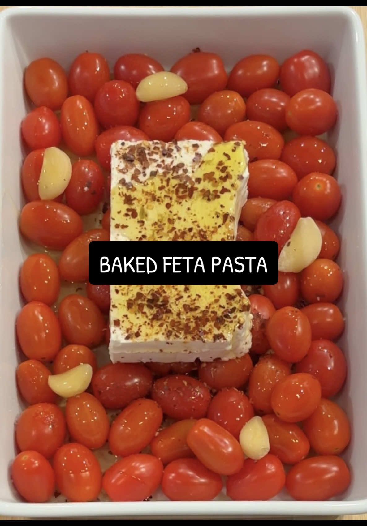 Baked Feta Pasta Recipe 👇 Coming Soon! The Unofficial Eras Tour Cookbook … Follow me for launch details 1/2 lb pasta noodles of your choice 8 oz block feta cheese 2 pints cherry tomatoes 1/2 cup olive oil 4 - 5 garlic cloves 1/2 tsp red pepper flakes 1/2 cup fresh basil or 1 tbsp dried basil Preheat oven to 400 F. Fill a large pot with water, add a tbsp of salt and bring to a boil. Add the pasta to the pot and boil until cooked but firm. Strain and set aside. 
 Place cherry tomatoes in an oven-safe dish. Add 1/4 cup of olive oil and season with salt and pepper. Toss until well combined. 
 Place the feta block in the middle of the dish on top of the tomatoes. Place the whole garlic cloves around the cheese block. Sprinkle the red pepper flakes and drizzle the remaining olive oil. 
 Bake for 20 minutes until the tomatoes burst and the cheese is melting. Remove from the oven and break the feta apart with a fork combining with the tomatoes until the sauce gets creamy. 
 Sprinkle in the basil, add the cooked pasta, and toss until the pasta is well coated. #Recipe #taylorswift #swiftie #erastour #pasta 
