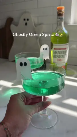 Ghostly Green Halloween Cocktail 👻✨  The recipe: - 1 ounce of @Absinthe Absente  - 1 teaspoon simple syrup - 4 ounces of prosecco/champagne - Add green edible glitter   Mix all ingredients together, pour into a couple glass and add some fun festive halloween glass  markers! A must add recipe to your next Halloween party!  #halloween #cocktailrecipe #halloweendrinks #spritz #halloweenrecipe 
