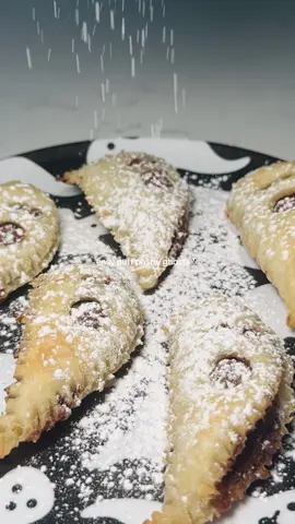 how cute are these?! perfect for a get-together and perfect for the fall season👻🤍 you need 3 INGREDIENTS  all you need: @Sweet Loren’s ✨ puff pastry  nutella or chocolate spread  powdered sugar to top! 1. grab a baking pan and place a sheet of parchment paper on it with the puff pastry.  2. take a heart shaped cookie cutter and make as many hearts as you can on the puff pastry  3. take a knife and cut the heart in half. on one side. use a straw or the end of a piping tip to create eyes. use the big side for the mouth 4. on the other side of the heart (the one without the eyes and mouth) place some nutella/chocolate spread. smear it on the pastry. 5. place the side with the face on top. take a fork and press down all around to ensure the pastry stays together while baking. curve the bottom to the left so they look like ghosts  6. at 425 F bake for approx 10-12 minutes or until golden brown  7. let cool, top with powdered sugar and enjoy 🫶🫶🫶 - #fyp #foryoupage #puffpastry #glutenfree #dairyfree 