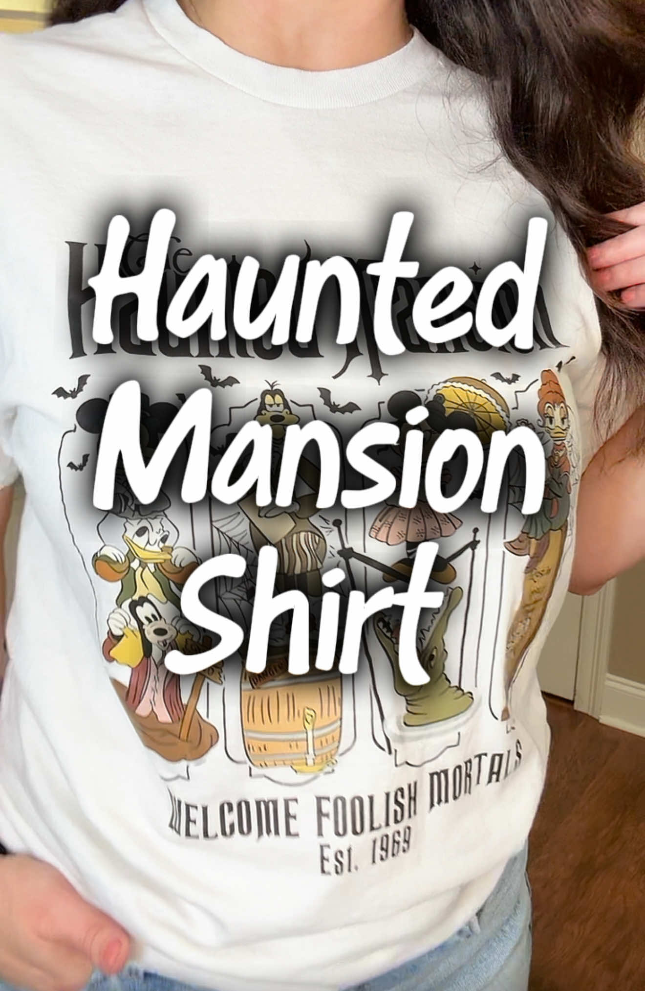 👻✨ Spooky season never ends with this Haunted Mansion tee 🏰🕯️ Tap to shop now! 🖤  • • #HauntedMansion #DisneyStyle #SpookySeason #TikTokMadeMeBuyIt #DisneyObsessed 