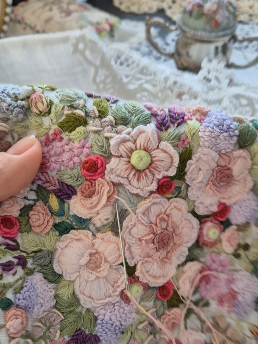 Invisible cast-on stitching  for the back side of my tablecloth canvas. When I look at my embroidery every day, sometimes I feel that I need to add one or two more details. And the fact that I can later embroider without leaving traces on the back double side of my canvas napkins or tablecloth, helps me a lot because I can complete my floral designs as I wish, down to the last small detail. . . . Painting invisible with mouline threads on linen cloth. Cast-on stitch embroidery flowers on tablecloths. Floral design handmade embroidery on canvas, white color. Creating beauty on the line. Flowers design threads needlework on linen napkin.