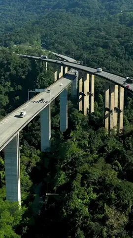 A Rodovia dos Imigrantes é uma das mais impressionantes do Brasil, conectando São Paulo ao litoral através de túneis e viadutos incríveis na Serra do Mar. 🚗🌄” @dronebaixadasp crédito das imagens  #RodoviaDosImigrantes #Viagem #Curiosidades #Brasil #Estradas