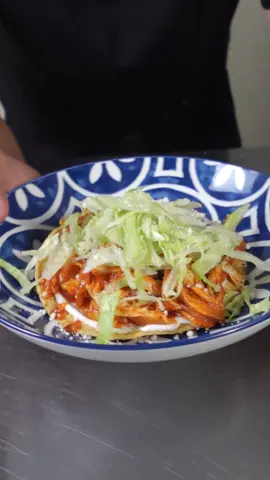 No more BLAND Chicken 🐔, Chicken Tinga will make your neighbor jealous!!  Ingredients 	•	1 ½ lbs chicken breast or thighs 	•	1 tsp oregano 	•	1 tsp salt  SAUCE 	•	5 medium tomatoes 	•	1/4 white onion  	•	2 garlic cloves 	•	1 chicken bouillon cube (or 1 tbsp bouillon powder) 	•	1–2 chipotle peppers in adobo (adjust to taste) Cooking  	•	1–2 tbsp oil 1/2 onion slice Shredded chicken Salt to taste  	•	Tostada shells 	•	Sour cream 	•	Shredded lettuce 	•	Queso fresco (crumbled) ⸻ Instructions 	1.	Cook the chicken 	•	Place the chicken in a pot with oregano, 1 tsp salt, and enough water to cover. 	•	Simmer over medium heat for 25 minutes, until fully cooked and tender. 	2.	Blend the sauce 	•	In a blender, combine tomatoes, ½ onion, garlic, bouillon, and 1 chipotle pepper. 	•	Blend until completely smooth. Taste and add more chipotle if you’d like extra heat. 	3.	Shred the chicken 	•	Remove chicken from the pot and shred finely with two forks (this keeps your hands from burning). 	4.	Cook the tinga 	•	Heat oil in a large skillet. 	•	Add the sliced onion and cook for about 2 minutes until softened. 	•	Add shredded chicken, pour in the sauce, and stir well. 	•	Taste and adjust seasoning with more salt if needed. Let simmer for 5 minutes. 	5.	Assemble tostadas 	•	Spread a layer of sour cream on each tostada shell. 	•	Add chicken tinga, then top with lettuce and queso fresco. #EasyRecipe #comfortfood #chickentinga  #mexicanfood #tostada 