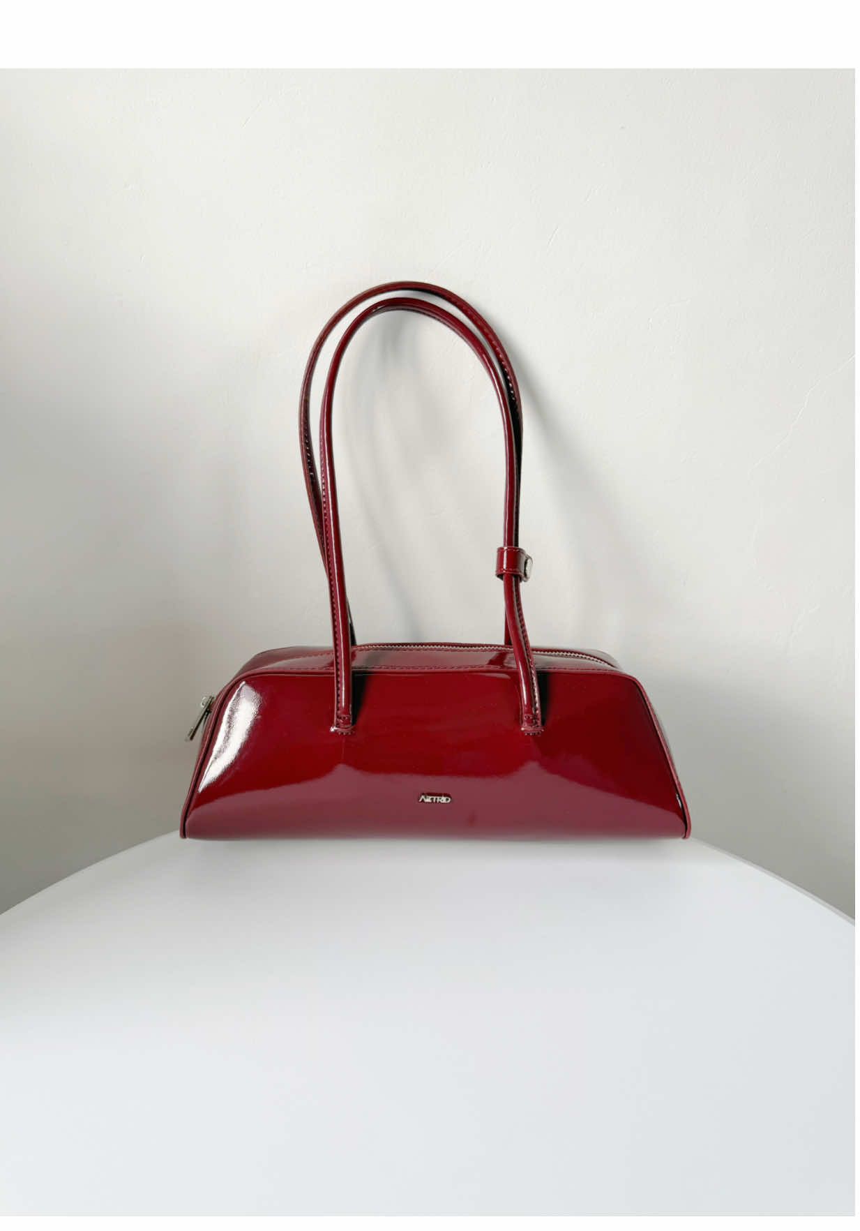 Replying to @AZTRID The burgundy bowling bag that literally swallows everything! #bowlingbag #shoulderbag #aztridbag #patentbag @AZTRID 