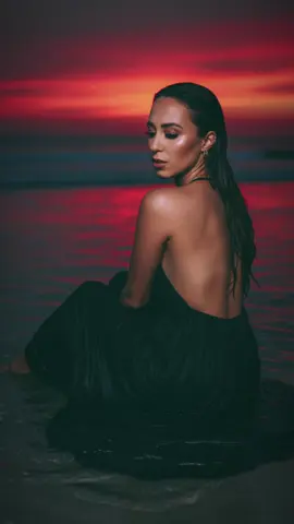 I think these Google Gemini photos are my fav! 🤩 I CANT STOP!!                                                Prompt: Create an image with this picture of a woman, her face looking at the camera. Her hair down, brown, long and wavy, slick back and wet. She is wearing an elegant long lime green backless dress with straps and it’s wet, and no shoes . She is lying in shallow water. Her face can be seen in profile and the expression looks thoughtful or dreamy as she looks down slightly. She is slightly posed. The background is in water in a beach, creating a dramatic effect. The dominant colors are black, red and gray. Shot is full picture. Makeup is eye-catching. Long, voluminous eyelashes. Impeccable skin contours. Lips full in brightness. 4k lens HD. Quality (keep facial details correctly)! Emphasizes skin texture and sharp eye detail. Make the woman look at the camera, take the picture up close. Do not change her facial features. Do not change her dark mid length hair. #googlegeminiai #ai #gemini 