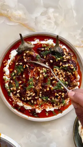 Burnt aubergine with feta and harissa oil.  Who hasn’t tried it yet?  Ingredients 60m olive oil 2 aubergines (about 500g) flaked sea salt 30g	 harissa 1 tbsp lemon juice 1 tbsp maple syrup 130g feta 50ml whole milk 15g	pine nuts, toasted 1 tbsp picked dill pitta, to serve (optional) Method 1. Set a griddle pan on a high heat and ventilate the kitchen. Rub a tablespoon of olive oil all over the aubergines. Once the pan is very hot, lay in the aubergines and char, turning them occasionally, for about 20 minutes (if your aubergines are big, give them a little more time), until blackened all over, but not grey and ashy. Transfer to a rack set over a tray and leave to cool. 2. Once the aubergines are cool enough to handle, carefully peel them, discarding the burned skins but keeping the stems attached and taking care not to break up the flesh too much. Using a small knife, cut each aubergine from top to bottom, but keeping it intact at both ends and making sure not to cut all the way through. Gently open up the aubergines, then season each one with a half-teaspoon of salt. Return the prepared aubergines to the rack, so any liquid drips off. 3. In a medium bowl, mix the harissa with the remaining 45ml olive oil, the lemon juice and maple syrup, and set aside. 4. With a fork, mash the feta with the milk in a small bowl until reasonably smooth, and set aside. 5. To serve, spoon all the feta mixture on to a large plate with a lip and, using the back of a spoon, spread it out into a circle with a 1½cm border around the edge of the plate. Baste the aubergines in the harissa mixture, then lay them side by side on top of the feta mix. Spoon any remaining harissa mixture on top of the aubergines, letting the oil run over the feta and out towards the edges of the plate. 6. Sprinkle over the pine nuts and the picked dill, and serve with warmed pitta, if you like.
