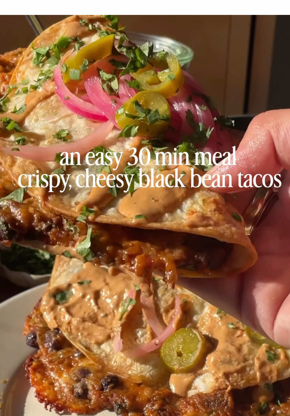 CRISPY black bean tacos! with my new chipotle tahini yogurt dipping sauce. Omg these are FAB and a great easy vegetarian dinner to keep on hand or in the freezer. All you have to do is: ✔️cook down some veggies (onion, pepper and garlic) ✔️add it to a food processor with black beans!  ✔️add the filling to tortillas with some cheese  ✔️pop on a baking sheet, bake until crispy and serve!  ➡️ find the full recipe below + on ambitiouskitchen.com!  🎥: @themindfulhapa ambitiouskitchen.com/crispy-black-bean-tacos  #taconight #easydinners #kidfriendly #tacos #vegetarian