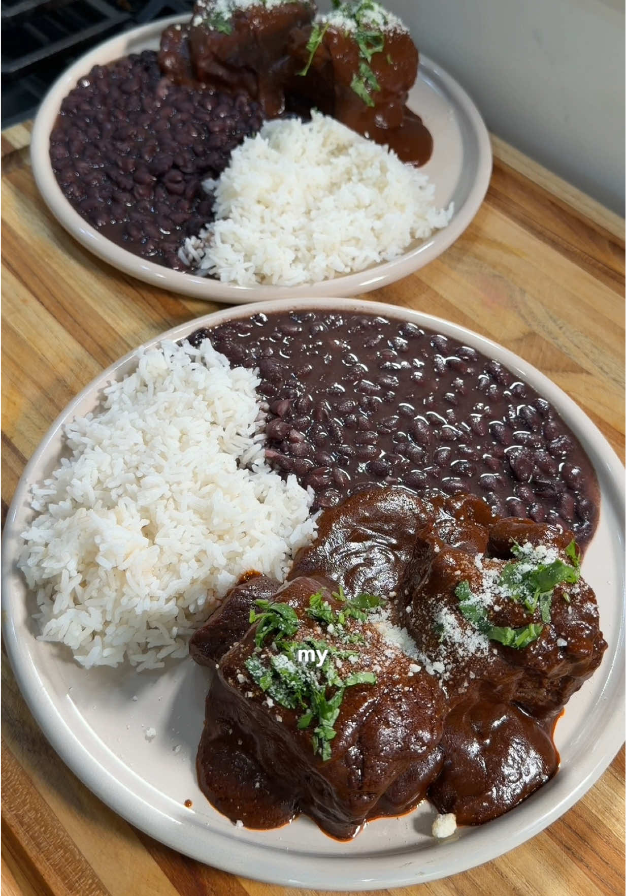 Recipe ⤵️ Short rib mole rojo the perfect way to impress anyone 🤍🥩 Ingredients: - 3-4lbs of beef short ribs - 1 can Dona Maria red mole sauce  - 5-6 guajillos (deseeded) - 5-6 California (deseeded) - Chile de arbole (depending on spice tolerance) - 3-4 cloves - 1 onion - 1/2 tsp oregano  - 2 heads of garlic  - 4 bay leaves  - 4-5 peppercorn  - 1/2 tsp pepper  - 1 tortilla - 1 tbsp neutral oil  - Carton beef broth  Directions: 1. Salt & pepper your short ribs on all sides. 2. Sear off over ribs in batches over med high heat, with a bit of oil,  a in large Dutch oven until both sides of ribs have a nice crust.  3. Add them back in with 1/2 an onion, head of garlic, cloves, 2 bay leaves, and cinnamon.  4. Lower heat and add in 3/4 carton of beef broth. Season with salt and pepper pepper.  5. Bring to a simmer, cover, and bake at 325F for 3ish hours. Until they’re nice and fork tender.  6. Right before they’re done start your sauce.   7. Add your peppers to hot water for 10-15 mins  to soften up.  8. In a frying pan w oil fry 1/2 an onion, 5-6 garlic cloves, and tortilla till nice and golden.  9. Once peppers are softened & everything is fried add to your blender along with Doña Maria mole rojo. 10. Add peppercorn, 1 tsp salt, oregano, the rest of your bay leaves, and about 1 1/2 cups of the broth from short ribs.  11. Blend until smooth. If you’re having trouble blending add more broth.  12. Fry your mole in a pan with a little oil, and thin it out by adding broth to your blender and pouring it into pan. You want a silky consistency, but still a lil thick. Adjust salt to taste once you get the consistency you want.  13. Add in your short ribs, bring to simmer, cover, and cook for 5-10 mins just so all those flavors come together.  14. Serve with white rice, black beans, cilantro, and queso fresco or cotija, and enjoy babe! #mexican #DinnerIdeas #molerojo #mole 