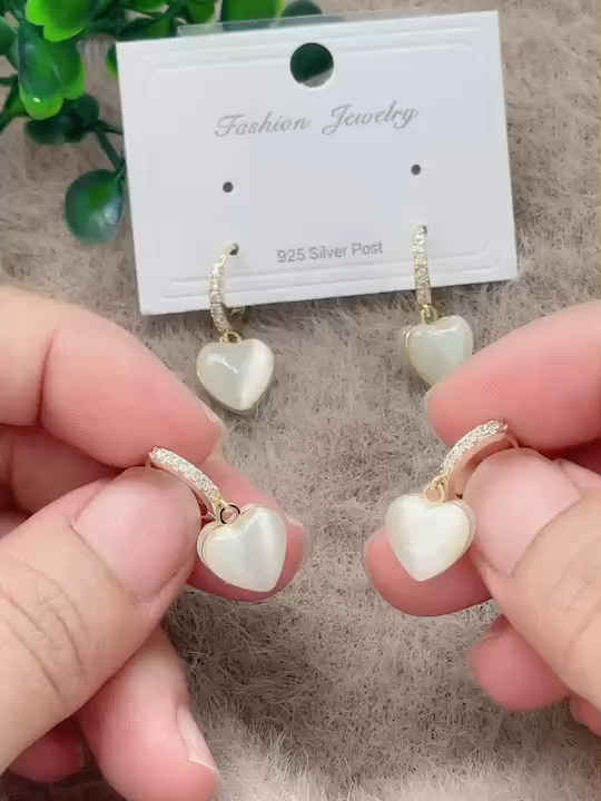 The purest expression of elegance. These clear opal earrings capture light with an iridescent fire.