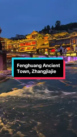 Day 5 – Fenghuang Ancient Town ✨ After arriving from Furong Town, we enjoyed lunch and took a short rest. Our hotel was right by the river, giving us a perfect view of Fenghuang’s charm. At around 6 p.m., when the sky began to dim, we stepped out to feel the evening atmosphere of the ancient town. The riverside came alive as lanterns started to glow, their warm reflections dancing on the water. 🌙🏮 Later, as night fully embraced the town and the performances began, we bought tickets for a boat ride. Drifting along the river, we admired the stilt houses, glowing bridges, and lively streets. The sight of Fenghuang at night was like stepping into a living painting—magical, timeless, and unforgettable. 💫🚤 #FenghuangAncientTown #ChinaTravel #NightMagic #RiversideCharm #UnforgettableJourney