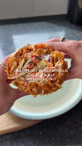 CREAMY HOT HONEY BUFFALO CHICKEN WRAP 🌯 This is the perfect high protein lunch or dinner!! 😍 It’s so tasty and takes no time at all to put together. Save for later to try for yourself☝🏼 •568 kcals per wrap •51g PRO, 58g CHO, 17g FAT Serves 1: -100g of uncooked chicken breast -5g of flour mixed with salt & pepper -1 egg, whisked -15g of panko breadcrumbs mixed with 1 tsp of paprika & 1 tsp of garlic granules  -Oil spray -50ml of Franks red hot buffalo sauce -10g of hot honey  -1 wrap -15g of cheddar/mozzarella  -20g of ranch sauce  Coleslaw (serves 3): -1/4 head of red cabbage, thinly sliced -1/4 head of white cabbies, thinly sliced -1 carrot, julienned  -80g of 0% Greek yoghurt -30g of light mayonnaise  -1 tsp of Dijon mustard  -Juice of 1/2 lime  -Salt/pepper  Method: 1. Coat the chicken breast in flour, then egg and then breadcrumbs. Spray with oil and air fry at 180C for 15-20 minutes. 2. Once done, slice into chunks.  3. Add to a bowl and mix with the buffalo sauce and hot honey. 4. For the coleslaw, add the red cabbage, white cabbage, carrot, yoghurt, mayonnaise, dijon mustard, squeeze of lime juice and salt/pepper to a bowl. Mix well.  5. Heat the wrap for 30 seconds in the microwave. 6. Assemble the wrap with the chicken, cheddar/mozzarella, 1/3 of the coleslaw and the ranch. Spread the ranch on top. 7. Fold in the edges, then roll and fold over tightly. Place on a sprayed pan for 2-3 minutes on each side until browned and crispy. 8. Slice in half when ready to eat. Enjoy! #buffalochickenwrap #hothoney #buffalochicken #wraps #highprotein  