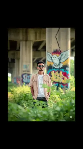 Realistic Photo Edit 😍 Prompt :- Ultra-realistic candid portrait, hidden through green wild plants as natural foreground blur. Setting under an abandoned highway overpass, concrete pillars with cracks, overgrown vegetation, and colorful graffiti murals including a large artistic white owl graffiti on the wall. Subject: a handsome young boy [use your reference face], wearing casual streetwear in a warming day,Sunglass on her eyes.... Camer:-close shoots take half body Follow, like, cmnt plz🫰 #gemini #ai #viral #trending  #CapCut 