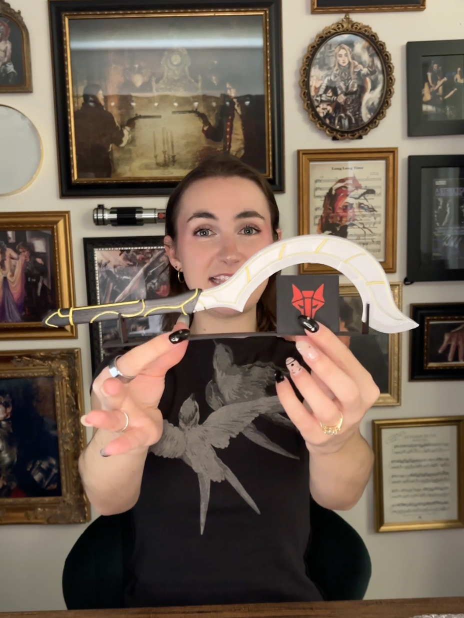 now the question is: does the slingblade go on my shelf or on the wall behind me? big shoutout to @rebelandfleur for having the cutest merch, @pixiedustmagicco for my new fave star wars shirt, and to @nickknotscustom for helping fulfill my dreams of owning a slingblade 🫡✨ #unboxing #haul #redrising #bookish #starwars