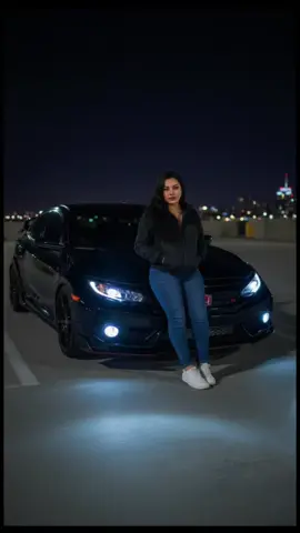 Crie uma foto minha na qualidade 4k,posando na frente de um honda civic 2018 typer r preto, rebaixado ,à noite e o angulo da foto é t levemente de lado para a câmera. a garota está parada na frente do carro e ela está sentada no centro do carro,na ponta do capô com a cabeça olhando fixamente para a câmera ,os  cabelos são longos, ondulados e escuros e uma jaqueta preta com mangas longas, calças jeans e tênis branco . As mãos estão dentro do bolso do casaco. O carro está com os faróis acesos, dando uma luz brilhante ao piso plano de concreto à sua frente, o que dá a impressão de que está em um estacionamento. Os faróis são alterados de LED,tunados. O fundo da foto é um estacionamento ao ar livre, possivelmente uma cobertura,de noite,que mostre bem o céu a noite,com iluminação dark,e levemente desfocada,pois o foco central é na modelo e no carro. Não altere o rosto. Ela tem uma expressão atraente #gemini #fyp #explor 