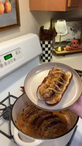 Beer bratwursts on pretzel buns with sauerkraut 🍺🥨🔥 The coziest fall dinner that’s hearty, flavorful, and so simple to make! Here’s how I do it ⬇️ Ingredients: 5 Beer bratwursts 1 package sauerkraut 1 pack pretzel buns 2 tbsp olive oil Garlic powder Onion powder Pepper Paprika 1 tbsp Mike’s Hot Honey or 1 tbsp brown sugar 3 tbsp apple cider vinegar Mustard for topping Directions: 1️⃣ Heat olive oil in an oven-safe pot (I used my Dutch oven). 2️⃣ Brown bratwursts ~4 min per side on medium-high (they don’t need to be cooked through). 3️⃣ Add apple cider vinegar, seasonings & honey. 4️⃣ Bake at 350°F for 1 hour, flipping halfway. 5️⃣ Warm pretzel buns in the last 5 minutes. 6️⃣ Serve with sauerkraut & spicy mustard — cozy, simple, and so good! #EasyRecipes #FallFood #ComfortFood #DinnerInspo #DinnerIdeas 