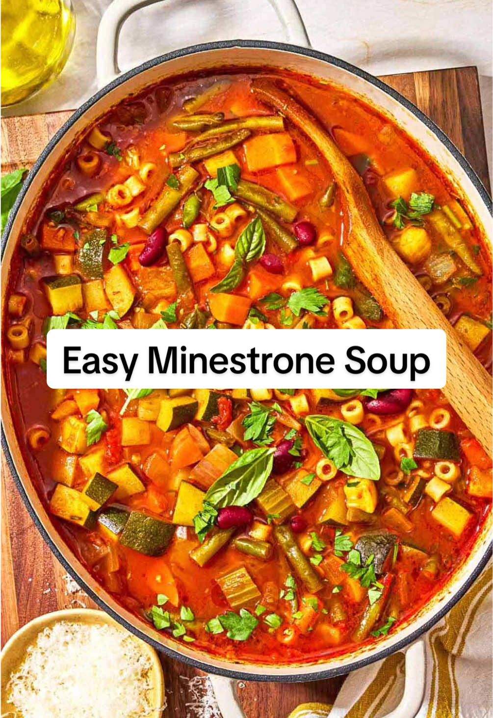 Easy Minestrone Soup - the perfect soup recipe to use up whatever vegetables you have on hand!  This vegetarian soup recipe is healthy, budget-friendly, and totally adaptable to what you have on hand. Minestrone soup is a hearty Italian soup made with vegetables, beans, pasta, and a flavorful, rich tomato-based broth. Italians call this type of recipe “cucina povera,” which means “poor kitchen,” because it was primarily made with whatever was available.  The beans provide fiber and vegetarian protein, while the pasta provides heft and body.  Here’s how you make it:  ▢ 1 cup ditalini or elbow pasta ▢ 1/4 cup extra virgin olive oil ▢ 1 small yellow onion chopped ▢ 2 carrots chopped ▢ 2 celery stalks diced ▢ 4 garlic cloves minced ▢ 1 zucchini or yellow squash diced ▢ 1 cup green beans trimmed and cut into 1-inch pieces ▢ Kosher salt ▢ Black pepper ▢ 1 teaspoon paprika ▢ 1/2 teaspoon dried rosemary ▢ 1 (15-ounce) can crushed tomatoes ▢ 6 cups vegetable or chicken broth, ▢ Parmesan cheese rind optional; about 1-inch long ▢ 1 dried bay leaf ▢ 2 to 3 sprigs fresh thyme ▢ 1 (15-ounce) can kidney beans, drained and rinsed ▢ 1 large handful parsley chopped ▢ 1 handful fresh basil leaves ▢ Grated Parmesan cheese to serve (optional) 1️⃣Cook the pasta. Bring a large pot of salter water to a boil over high heat. Add the pasta and cook to al dente according to the package directions. Drain. 2️⃣Soften the aromatics. Heat the olive oil in a large Dutch oven over medium heat until shimmering but not smoking. Add the onions, carrots and celery and raise the heat to medium-high. Cook, stirring regularly, until the veggies soften a bit, about 5 minutes. Add the garlic and cook another minute, tossing regularly. 3️⃣Cook the veggies. Add the zucchini or yellow squash, green beans, paprika, rosemary, and a generous pinch of salt and pepper. Toss to combine. 4️⃣Make the soup. Now add the canned tomatoes, broth, fresh thyme, bay leaf and Parmesan rind (if using). Bring to a boil, then reduce the heat to a gentle simmer and partially cover the pot. Let simmer for about 20 minutes or so. 5️⃣Finish the minestrone. Uncover the pot and add the kidney beans. Cook for another 5 minutes, then stir in the parsley and fresh basil. Just before serving, stir in the cooked pasta and simmer just until the pasta is warmed through; do not overcook. 6️⃣ Serve. Remove the cheese rind and bay leaf. Taste and adjust seasoning to your liking. Serve the minestrone hot with a sprinkle of grated Parmesan (if you’d like) and a drizzle of extra virgin olive oil on top. #minestrone #soupseason #souprecipe #vegetariansoup #healthysoup 