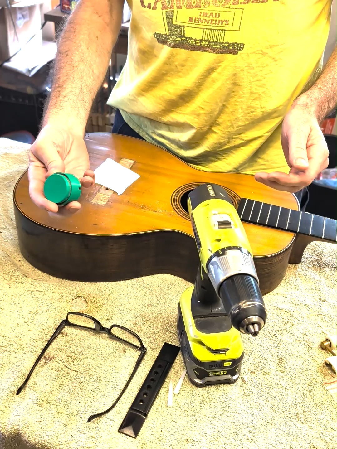 Someone had glued on this oversized and thick bridge plate so I'm thinning it out with this clever little disk sander. #guitar #luthier #guitartok #acousticguitar