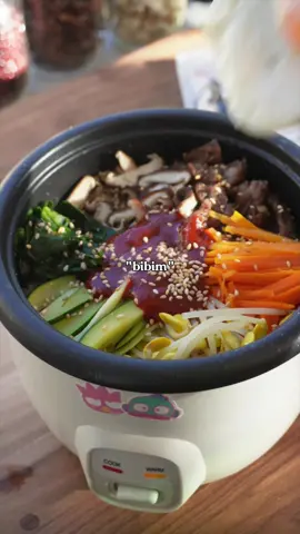 EP 20. Rice cooker bibimbap! If you don’t care about overcooked ingredients feel free to put the toppings in at whatever point. The timing below is what works for me in my Aroma 2 cups uncooked one push rice cooker! For the beef I marinaded 3oz of sliced beef with 1/2 tbsp soy sauce, 1/2 tbsp oyster sauce, 1 tsp honey, and minced garlic. **As usual the water to rice ratio may differ depending on the kind of rice you use! Cooking times may also differ depending on your rice cooker model.** My rice cooker is a 2 cups uncooked / 4 cups cooked size. Ingredients 3/4 c rice 1 c water 3oz marinade thinly sliced beef (see above) 1 oz sliced mushrooms Thinly sliced carrots Thinly sliced zucchini Spinach Soy bean sprouts Toasted White Sesame Seeds Bibimbap sauce Egg 1. If you want an egg, you will need to fry it first IF you ONLY have a rice cooker 2. Combine rice and water. Let Cook. 3. After about 10 minutes, add the marinaded beef and sliced mushrooms on top of the rice. 4. Continue cooking for 6-7 minutes. Add the additional vegetables and let everything finish 5. Top with bibimbap sauce, toasted white sesame seeds, and the egg! #cookininricecooker #ricecooker #ricecookerrecipe #koreanfood #bibimbap
