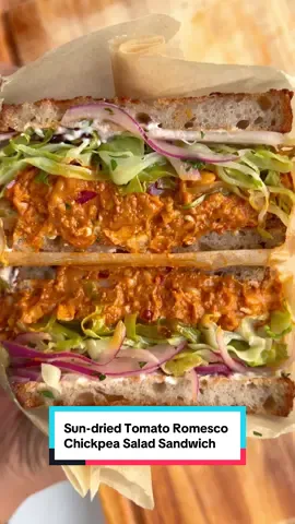 🥪 Sun-dried Romesco Chickpea Salad, perfect stuffed into sandwiches layered with roasted veggies, marinated onions, and some tofu cream cheese. Meal prep the filling a head of time to make getting some protein and fiber more enjoyable 😌 #plantbasedrecipes #sandwich #chickpeasalad  Sun-Dried Tomato Romesco 2 tbsp olive oil 3 garlic cloves 1 jalapeño pepper (for reference I used a red jalapeño) 1/2 cup roasted red pepper from a jar, drained 1/4 cup sun-dried tomatoes from a jar packed in oil, drained 1/4 cup pecans 2 tbsp red wine vinegar or sherry vinegar 1/2 tsp smoked paprika 2 tbsp parsley leaves Kosher salt Chickpea Salad 1, 15 oz can chickpeas, drained and rinsed 1/3 cup roasted bell pepper from a jar, diced 1/4 cup red onion, diced 1/4 cup sun-dried tomatoes from a jar packed in oil, julienned 1 jalapeño, thinly sliced (optional) Sandwich Accessories Roasted shredded cabbage Marinated or pickled onions (1/2 red onion, juice of 1 lemon, 1 tsp red wine vinegar, 1 tsp maple syrup, 1 tsp extra virgin olive oil, 2 tbsp parsley, pinch of kosher salt) 6 slices of toasted sourdough bread Vegan cream cheese (optional-store bought or use my homemade tofu cream cheese for more protein) Full instructions, ingredient substitutions, storage info and more can be found on my site listed in prof ile 🫶🏽