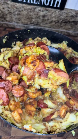 Fried Cabbage with Shrimp, Sausage & Bacon Ingredients: 	•	1 lb shrimp, peeled & deveined 	•	1/2 lb sausage, sliced 	•	4 slices bacon, chopped 	•	1 medium head cabbage, washed & chopped 	•	1 stick butter 	•	2 tbsp olive oil 	•	1 tsp garlic powder (plus extra for cabbage) 	•	1 tsp onion powder (plus extra for cabbage) 	•	1 tsp paprika 	•	1 tbsp Old Bay seasoning 	•	1 tbsp Cajun Two Step seasoning 	•	Salt & pepper to taste Instructions: 	1.	In a bowl, coat shrimp with olive oil, garlic powder, onion powder, paprika, and Old Bay. Set aside. 	2.	In a large skillet, cook chopped bacon until it begins to crisp. Add sliced sausage and brown together. Remove and set aside. 	3.	Increase heat to high. Sear shrimp 1 minute per side, then remove and add to meat mixture. 	4.	In the same skillet, add butter and chopped cabbage. Cover until butter melts. 	5.	Season cabbage with Cajun Two Step, garlic powder, and onion powder. Stir and fry until tender. 	6.	Return shrimp, sausage, and bacon to the skillet. Mix well until fully combined. 	7.	Serve hot and enjoy! #cabbagerecipes #shrimp #sausage #bacon #southerncooking    