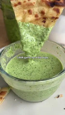CAVA GARLIC HERB DIP DUPE  How fortunate am I to have accidentally found out their garlic herb dip is just their garlic sauce mixed with skhug 🤫 So here are 3 sauce recipes that you definitely want to save.  Recipes 👇🏻 Garlic Sauce 🧄 1/2 cup garlic cloves 1/4 cup lemon juice  3 tbsp aquafaba  3/4 cup canola oil  1. Remove the garlic skins and trim off the ends. 2. Use an immersion blender (or a regular one) and blend the garlic with lemon juice and aquafaba.  3. Slowly add in the oil and blend until it emulsifies and turns a bright white.  Skhug 🌿 🌶️  1 bunch of cilantro 2 jalapeños (remove the seeds) 1 spicier pepper of choice *optional* 5 garlic cloves 1/2 tsp cumin 1/2 tsp coriander  1/4 cup water  1/2 tsp salt 1/4 olive oil  1. Add cilantro, peppers, garlic, spices and water to a food processor and blend. 2. Gradually add the oil until the mixture is smooth and emulsified.  3. Let sit in the fridge for at least 30 minutes so all the flavors develop.  Garlic Herb Dip 🧄 🌿  1. Mix the two together and thank me later 😜 #cava #dip #garlic #feedfeed #nutrition    