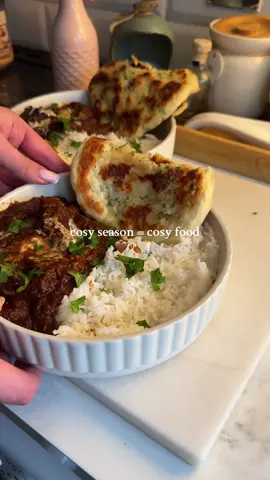 Easy peasy beef curry & homemade garlic naan 😍 comfort food season is BACK 🤎  I love my tiny lil kitchen in this weather because it’s soooo cosy. Everything is dimly lit, candles on, lots of fairy lights 🥺 Aaron tells me I have an irrational fear of big lights which tbf he isn’t wrong 🤣 Beef curry recipe to make 2-3 portions:  2 tbsp ghee  500g diced beef / braising steak  1 tin chopped tomatoes  2-3 tsp lazy garlic / 3-4 garlic cloves  2 tsp ginger  1 beef stock cube + 300ml water  1 diced red onion  1 tsp coriander powder  1 tsp tumeric  2-3 tsp chilli powder (adjust to your liking) 1 tsp garam masala  3 cardamon pods  2 tsp single cream (optional)  Garnish: fresh coriander Begin by browning off the beef in a pan for a few minutes until browned off, then leave to one side. In the same pan, add the ghee, garlic and ginger and fry off for a couple minutes until fragrant, then add in the diced onion. Add in all your spices, followed by the tin of chopped tomatoes and beef stock. Add the beef back into the sauce, season well with salt and pepper, then pop the lid on and cook on low for around 1 hour / 1 hour 30 mins until the beef is tender and falls apart.  Serve with basmati rice and homemade naan!  Homemade naan recipe (to make two)  120g 0% fat Greek yoghurt  110g self raising flour  20g butter  20g garlic puree  2 tsp parsley  Mix together the flour and yoghurt in a large bowl, until a crumbly texture forms. Mould into a large dough ball, then split it into two equal sized dough balls. Flatten out into desired naan shape.  Add a few tsp of oil to a pan and heat for a few mins, then fry the naan on either side, for around 4-5 mins each side or until each side begins to bubble and turn brown (keep an eye on it and keep turning so it doesn’t burn!). Just before serving, spread a layer of garlic butter onto one side of the naan.  I also found these chicken pakoras from Morrisons! They were goood 😍😍 #fyp #foryou #recipes #EasyRecipes #homecooking 