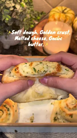 Soft, golden, cheesy and full of garlicky-butter goodness Roll 🥖 Dough Ingredients: * 1 egg (room temp) * 3.5 cups all-purpose flour (add more as needed until dough is no longer sticky) *  1 tsp garlic  * 1 tsp salt  * 1 tbsp sugar  * 1 Tbsp active dry yeast * ¾ cup warm whole milk  * 1/2 cup melted butter (for the dough) 🧈 Garlic Butter Filling: * ½ cup butter, room temp  * 4 minced garlic cloves, minced * 2 Tbsp fresh parsley                                   * 1 tsp salt and 1/2 tsp black pepper        * 1.5 pound of cheese if your choice( I used 1 pound mozzarella and 1/2 pound of Monterey Jack)  🍞 Instructions: 1. Activate Yeast: In a bowl, mix warm milk and sugar. Add yeast and let sit until foamy (about 5–10 mins). 2. Make the Dough: Add melted butter, egg, and seasonings to the yeast mixture. Gradually add flour and knead until smooth and elastic. Cover and let rise in a warm place until doubled (about 1 hour). 3. Prepare Filling: Mix all filling ingredients in a bowl until well combined. 4. Shape the Rolls:     * Roll dough into a rectangle.     * Spread garlic butter mixture evenly.     * Roll it up and slice into rolls.     * Place into a baking sheet  5. Second Rise: Let rolls rise again for ~15 minutes while you preheat oven to 350°F  6. Bake: Bake for 25–35 minutes until golden on top. 7. Finish: While warm, brush rolls with any leftover garlic butter. ✨ Tips: * Serve warm for the ultimate melt-in-your-mouth experience.       #CheeseGarlicRolls #GarliccRolls #cheeselover #CheeseLoversr