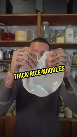 Chinese rice flat noodles 🍜  🍜 NOODLES  * 260 g rice flour * 40 g potato starch (or tapioca starch) * 600 ml water * Pinch of salt * Neutral oil, for brushing 🧂🥣🌶️Condiment / Sauce * 2 tbsp peanut butter (smooth) * 1 tbsp chili flakes * 1 tbsp garlic, finely minced * 2 tbsp sesame seeds * 3 tbsp soy sauce (use tamari for GF) * 1 tbsp chopped chives or spring onion * 200 ml neutral oil (for heating & pouring) Optional add-ins * Quick stir-fried veggies (e.g., carrot, peppers, bok choy, mushrooms) 🥣Preparation  Mix 260g rice flour, 40g potato starch, a pinch of salt, and 600ml water until smooth. Brush oil on a non-stick pan or silicone tray, pour a thin layer of batter, and steam for 3–4 minutes until set. Cool the sheet in cold water for 1 minute, unstick, brush with a little oil, roll up, and cut into 1 cm noodles. Repeat until all batter is used. In a heatproof bowl, add 2 tbsp peanut butter, 1 tbsp chili flakes, 1 tbsp minced garlic, 2 tbsp sesame seeds, 3 tbsp soy sauce, and 1 tbsp chopped chives/spring onion. Heat 200ml neutral oil until shimmering and pour over the mix — it will sizzle! Stir well. Toss the noodles in the hot sauce, add a splash of hot water if needed, and finish with optional stir-fried veggies. Serve and enjoy! 🍜✨ #noodles #chinesefood #chineserecipe #ricenoodles #fyp 