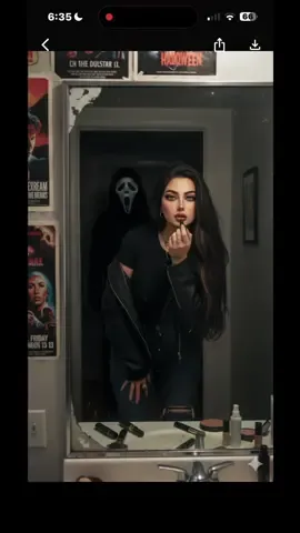 ghostface in the Bathroom   كليشة الشبح  كيف اسوي كليشة الشبح في المراية في  gemini  Ai gemini photo prompt  1افتحي تطبيق gemini  2حطي صور شخصية الك  3انسخي الكلام و حطيه تحت الصورة وبس   Prompt:  First of all don’t change my face features, same eyes shape, same nose shape, same lips shape, same face structure Create a photo of me in a grungy style portrait of me bending over in front of a retro bathroom mirror her eyes and face Looking straight directly at the camera  while applying lipstick ,in a black shirt with dark distressed jeans and a oversized black leather jacket. her hair brunette  flowing around her face. she wears delicate jewelry including dainty gold necklaces and accessories and silver chunky rings. her makeup is glamorous with dark look. the photo should have a grainy 90s style to it. There's makeup laying around her. The walls have scary movie posters. A man in a ghostface costume should be behind her staring at her, his body should be dimly lit, and he should be standing in the doorway of a dimly lit hallway. the background behind he should be slightly dark and ominous. Do not alter facial features #creatorsearchinsights #cinematicphotography ##aigemini #viral #ai 