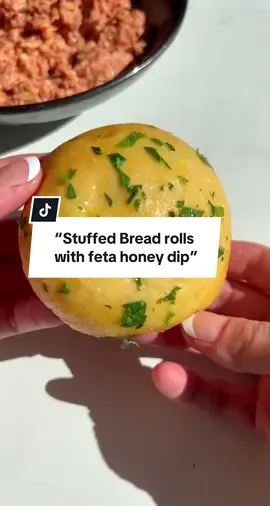 “Stuffed Bread rolls with feta honey dip”     stuffed breadrolls with feta dip is A delicious combination of cheesy doay warm bread with a sweet and salty dip and is one of my favorite side dishes that i love making Ingredients:  3 (16oz) cans of refrigerated Biscuits,  2 blocks (1lbs) of fresh low moisture Mozzarella, cut into finger sized pcs 1 egg, for egg wash  For the butter spread: 1 Garlic head, roasted  1-2 tbsp chopped Parsley  1/2 stick melted butter Parmesan cheese, grated (optional)   For the dip:  1 block feta Cheese 1/2 cup greek yogurt 1-2 tbsp chilli oil 1/4 cup honey Grated lemon rind  2 tsp lemon juice 2 tsp Aleppo Pepper,  Extra honey for drizzling   Method:  Preheat oven to 350F  To prepare the dip: place all ingredients in a large bowl and mix until well combined, place in the fridge.  To prepare the bread:  In a bowl, mix melted butter with roasted Garlic and chopped Parsley, set aside.  Pop the containers of the Biscuits open, spread evenly with a rolling pin, add 1-2 pcs of Mozzarella Cheese, close the dough all around until it forms a ball, place in a 12 inch buttered oven dish , repeat process until all balls have been formed, brush egg wash on top and place in the oven for 25 min or until golden.  For the garlic butter:  Add roasted garlic (you can use fresh ones too), melted butter, parsley snd parmesan in a bowl and whisk until well blended, set aside. For the feta spread:  Place all ingredients(except the Aleppo pepper & extra honey) and blend until smooth, transfer to a bowl, sprinkle Aleppo pepper and a drizzle of honey, set aside.  Brush bread with melted Butter and serve with the feta dip. #cookingwithlamees #pullapartbread #fetadip #stuffedbreadrolls 